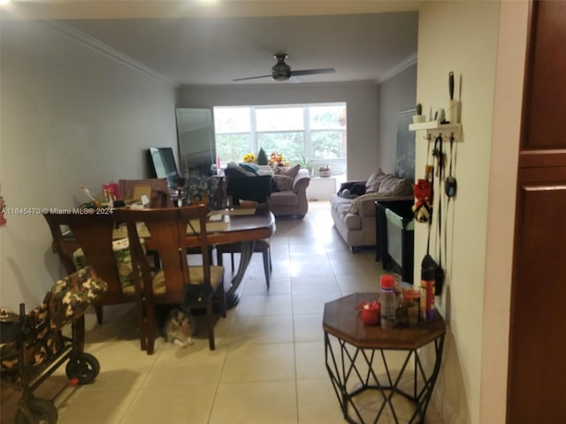 tiled dining room with ceiling fan and ornamental molding