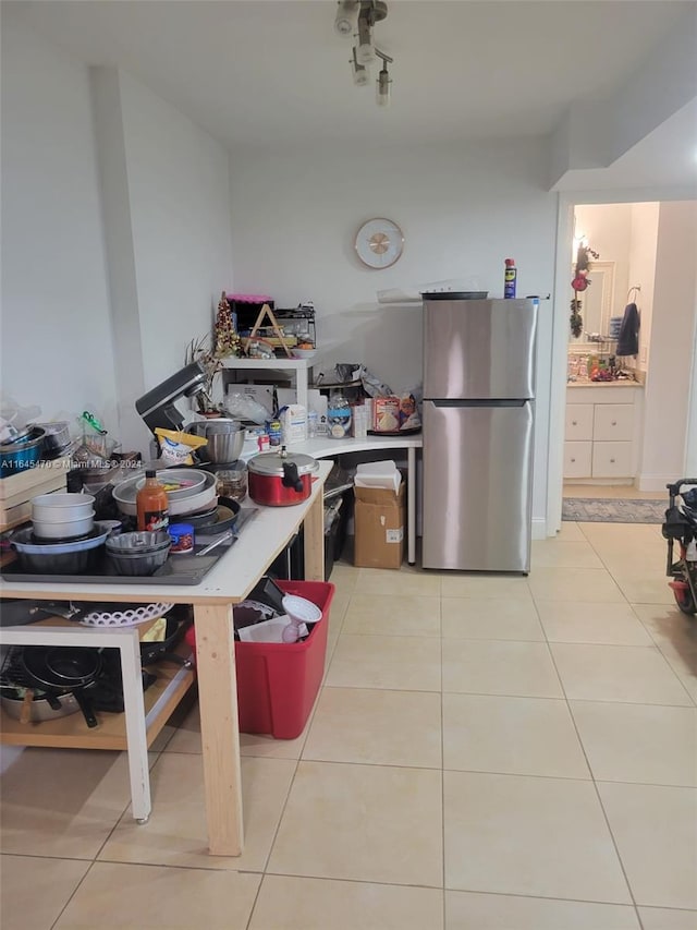 kitchen featuring light tile patterned floors and stainless steel fridge