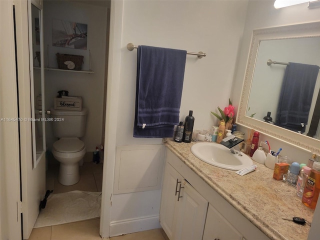 bathroom featuring toilet, tile patterned floors, and vanity