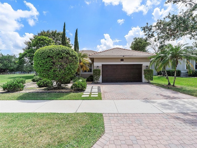 view of front of house with a garage and a front yard