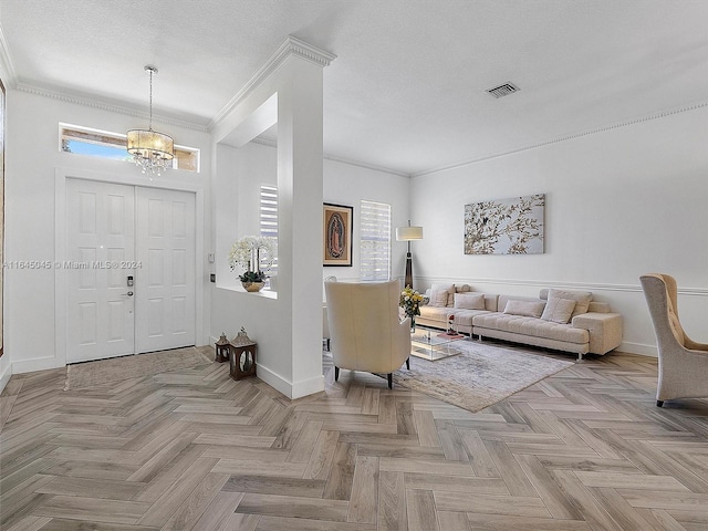 foyer entrance with visible vents, a textured ceiling, crown molding, baseboards, and a chandelier