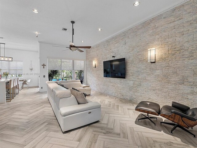 living room with ceiling fan, a textured ceiling, crown molding, and light parquet floors