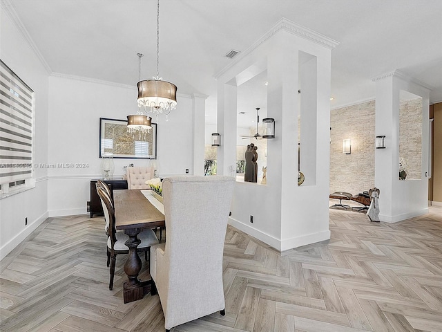 dining room featuring baseboards, an inviting chandelier, and crown molding