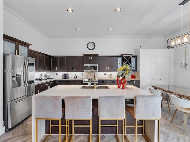 kitchen with stainless steel appliances, backsplash, and light countertops