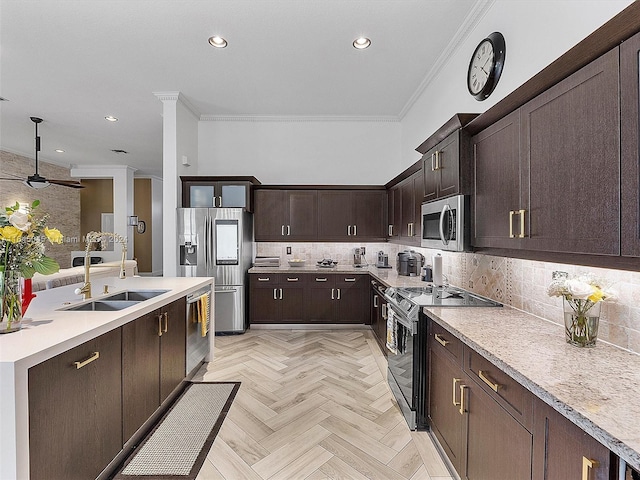 kitchen with sink, dark brown cabinets, light parquet flooring, ceiling fan, and stainless steel appliances