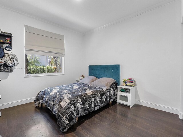 bedroom with hardwood / wood-style flooring and crown molding