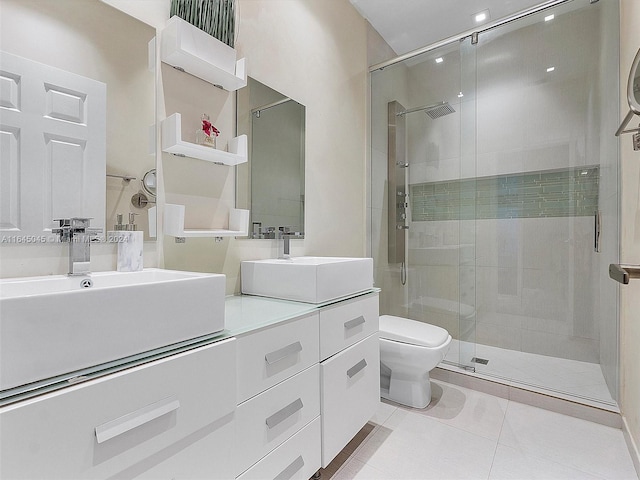 bathroom featuring tile patterned flooring, toilet, vanity, and walk in shower