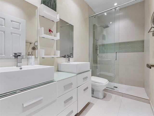 bathroom featuring tile patterned flooring, an enclosed shower, toilet, and vanity