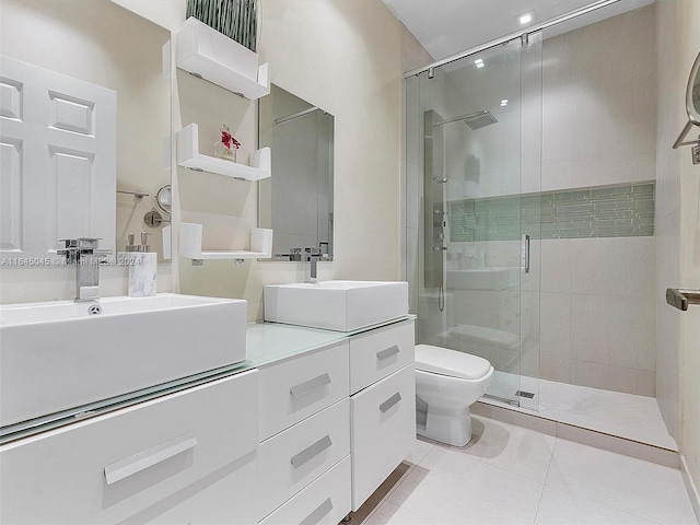 bathroom with a sink, toilet, a shower stall, and tile patterned flooring