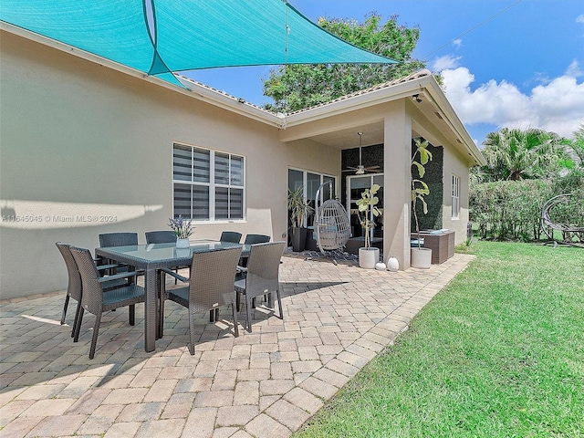 view of patio / terrace featuring outdoor dining space and a ceiling fan