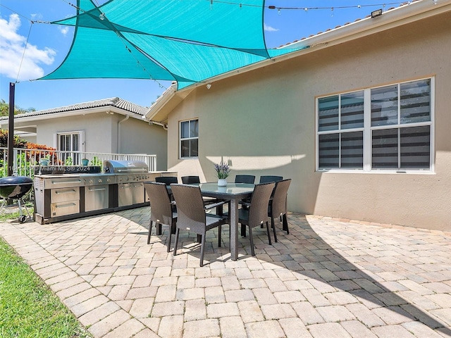 view of patio with outdoor dining area and grilling area