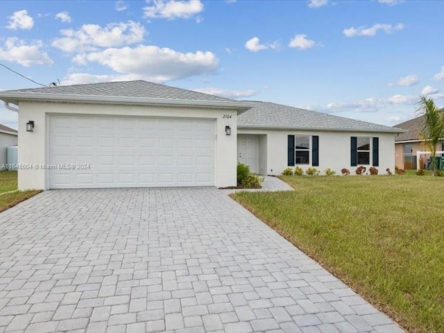 single story home featuring a front lawn and a garage