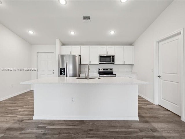 kitchen with a kitchen island with sink, stainless steel appliances, sink, dark hardwood / wood-style floors, and white cabinets