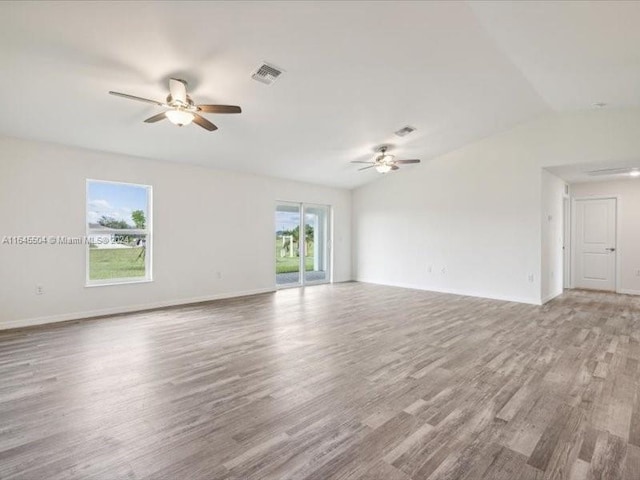 unfurnished room with vaulted ceiling, hardwood / wood-style floors, and ceiling fan