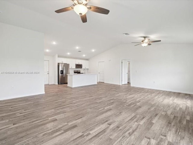 unfurnished living room with lofted ceiling, light hardwood / wood-style flooring, and ceiling fan