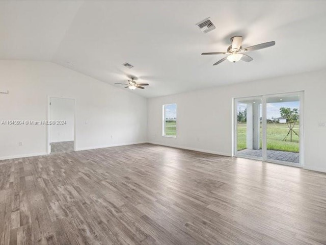 unfurnished room featuring ceiling fan, wood-type flooring, and vaulted ceiling