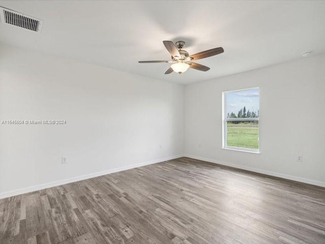 unfurnished room with hardwood / wood-style flooring and ceiling fan