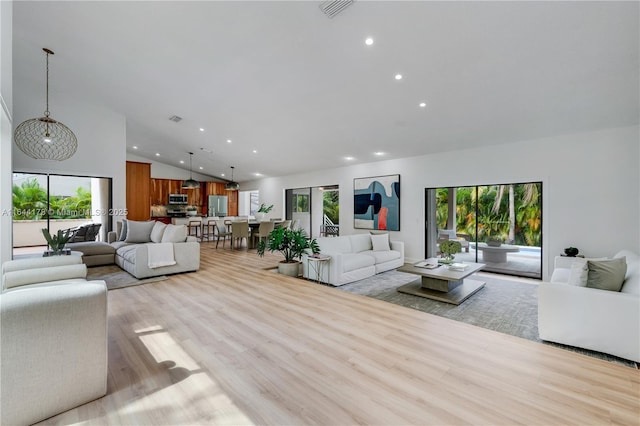 living room featuring light wood finished floors, visible vents, high vaulted ceiling, and recessed lighting