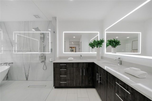 bathroom featuring double vanity, a marble finish shower, visible vents, and a sink