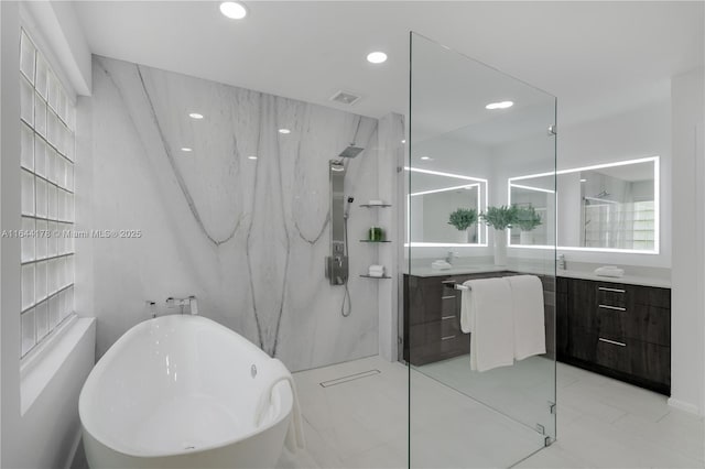 full bath with a marble finish shower, visible vents, a soaking tub, vanity, and recessed lighting