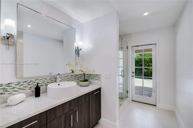 full bath with recessed lighting, backsplash, a shower stall, vanity, and baseboards