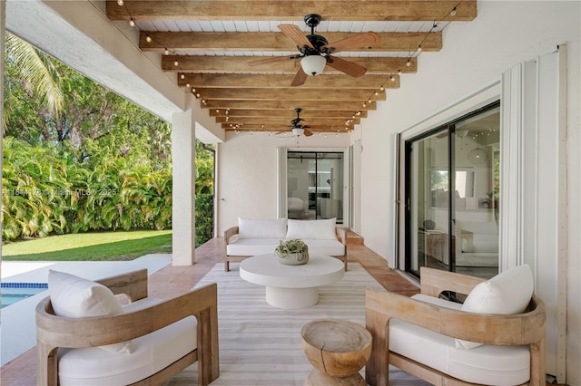 view of patio featuring ceiling fan and an outdoor pool