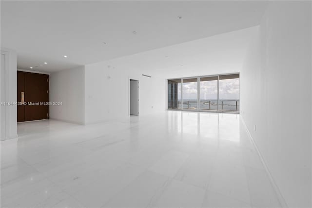 unfurnished room with expansive windows