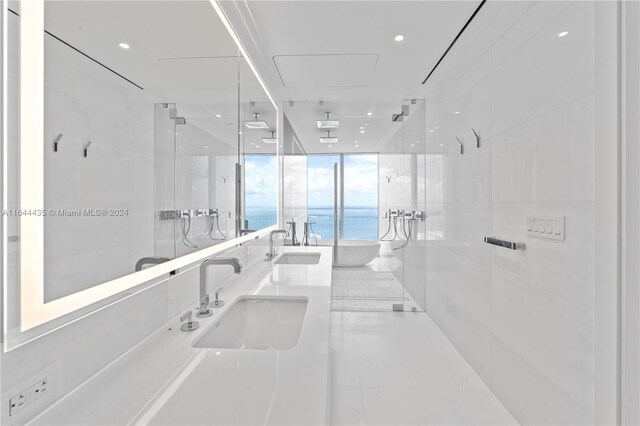 bathroom featuring vanity, a water view, walk in shower, and tile patterned flooring