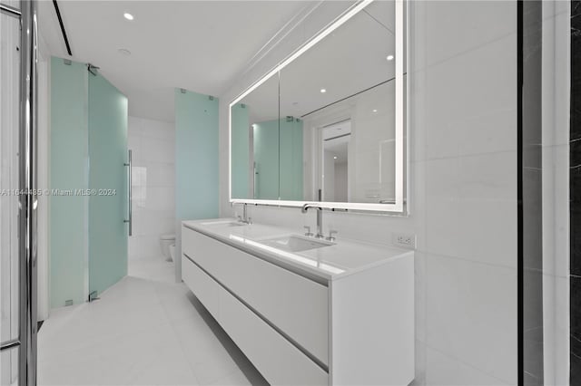 bathroom with vanity, toilet, and tile patterned floors