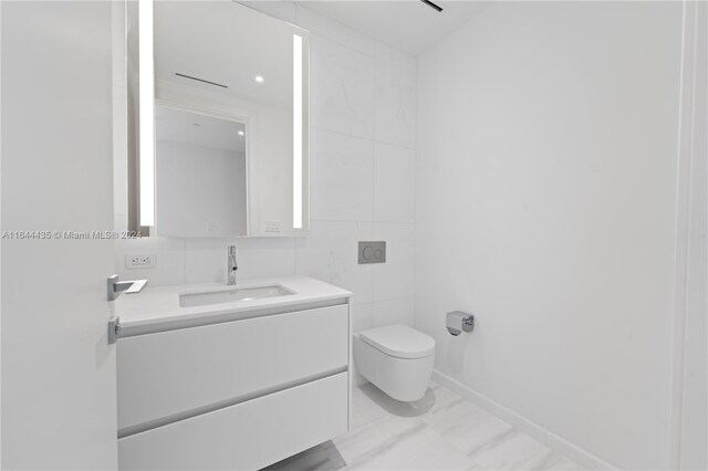 300 Biscayne Blvd Way Unit 4204, Miami, FL 33131 - bathroom featuring vanity, toilet, marble look tiles, and tile walls