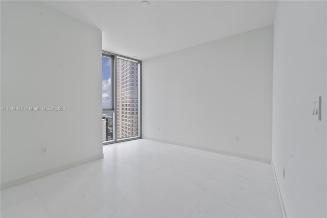 300 Biscayne Blvd Way Unit 4204, Miami, FL 33131 - unfurnished room with a wall of windows, baseboards, and tile patterned flooring