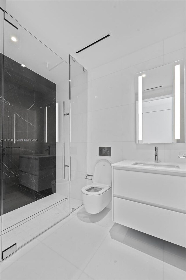 bathroom with vanity, walk in shower, tile walls, toilet, and tile patterned floors