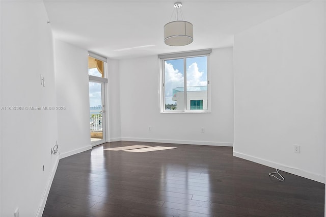 spare room with dark wood-type flooring