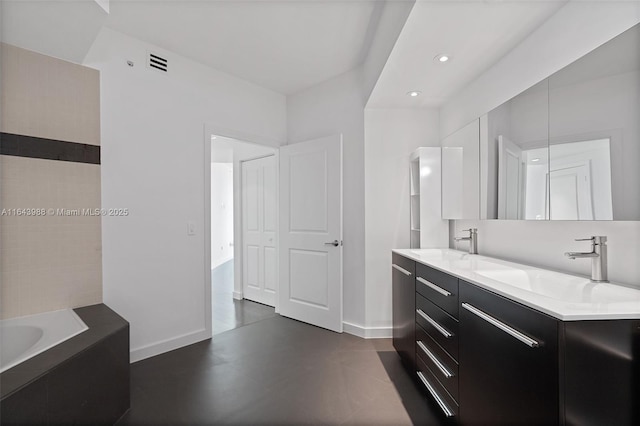 bathroom with vanity and a bathtub