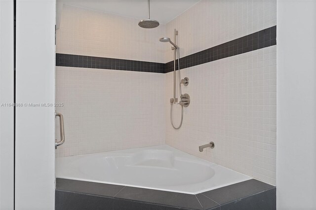 bathroom featuring tiled shower / bath