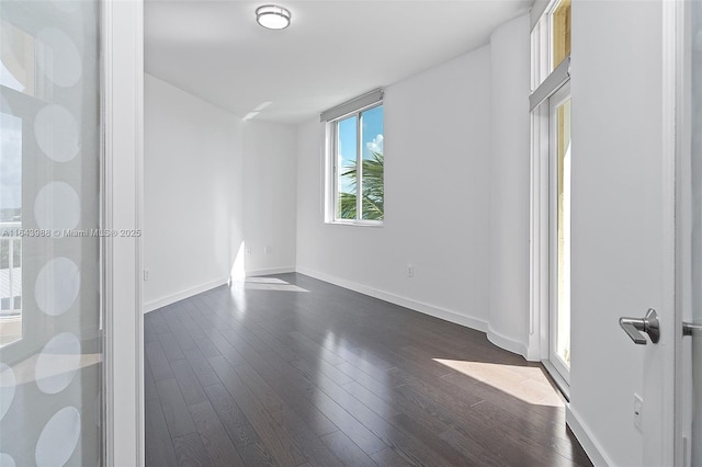 spare room featuring dark hardwood / wood-style flooring