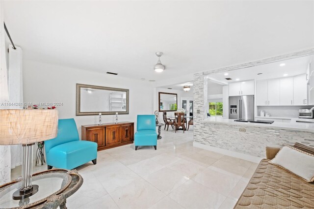 living room featuring light tile patterned flooring and ceiling fan