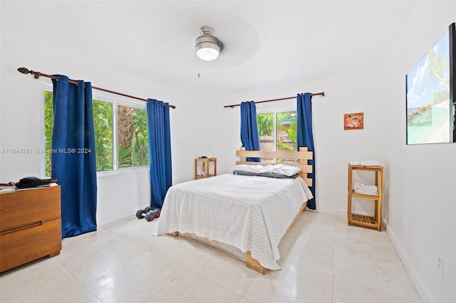 bedroom with ceiling fan and light tile patterned floors