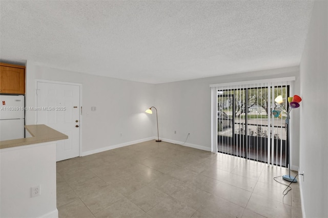 468 NE 206th Ln Unit 105, Miami, FL 33179 - empty room featuring baseboards and a textured ceiling