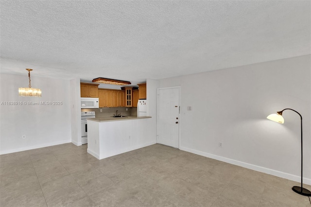 468 NE 206th Ln Unit 105, Miami, FL 33179 - kitchen featuring a sink, a peninsula, brown cabinets, glass insert cabinets, and white appliances