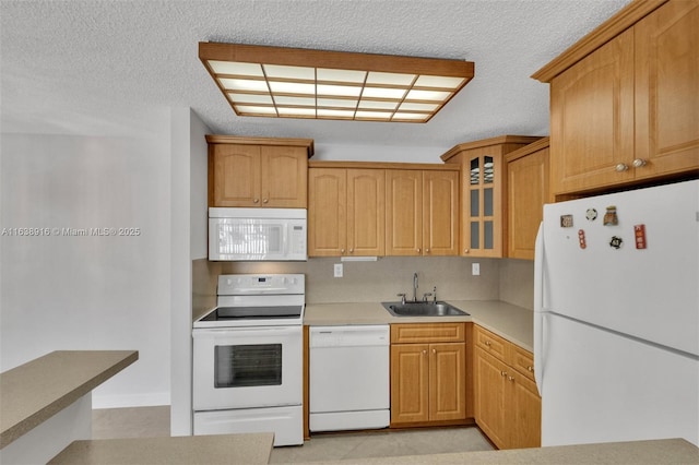 468 NE 206th Ln Unit 105, Miami, FL 33179 - kitchen with light countertops, a sink, a textured ceiling, glass insert cabinets, and white appliances