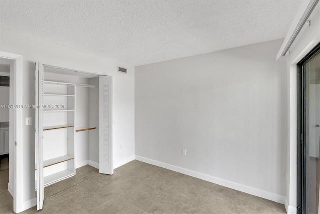 468 NE 206th Ln Unit 105, Miami, FL 33179 - unfurnished bedroom with a textured ceiling, a closet, and visible vents