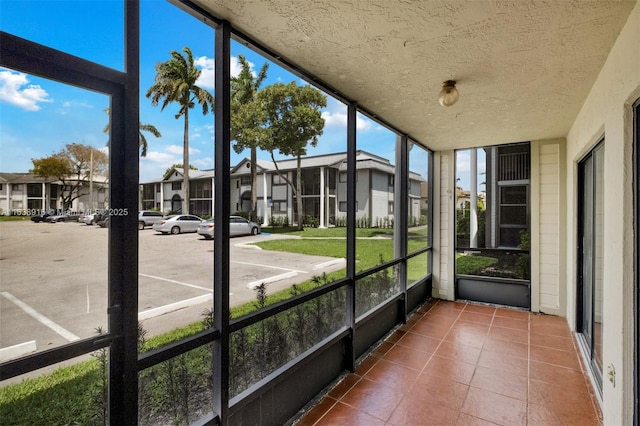 468 NE 206th Ln Unit 105, Miami, FL 33179 - unfurnished sunroom featuring a residential view and a healthy amount of sunlight