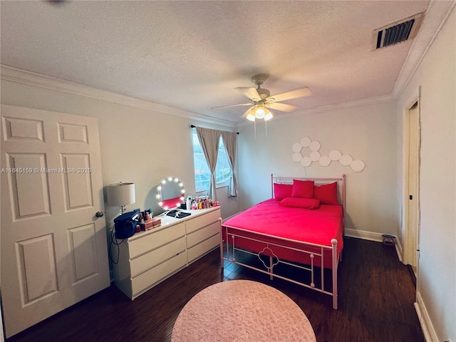 bedroom featuring ceiling fan, crown molding, dark hardwood / wood-style floors, and a textured ceiling