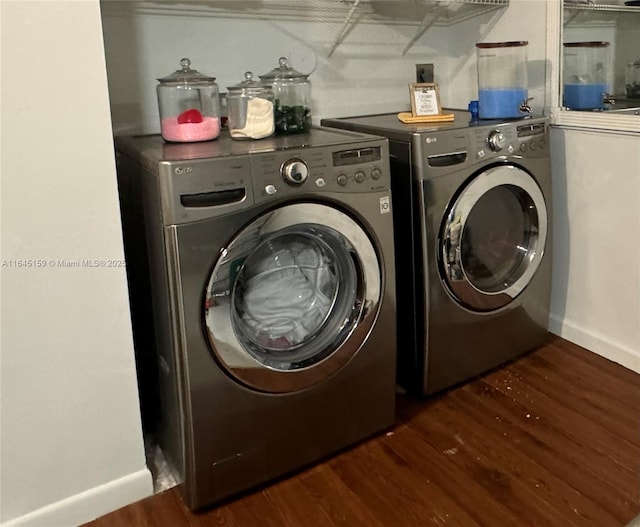 washroom featuring washing machine and dryer and dark wood-type flooring