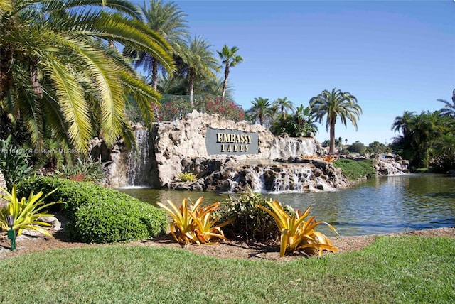 community / neighborhood sign with a water view