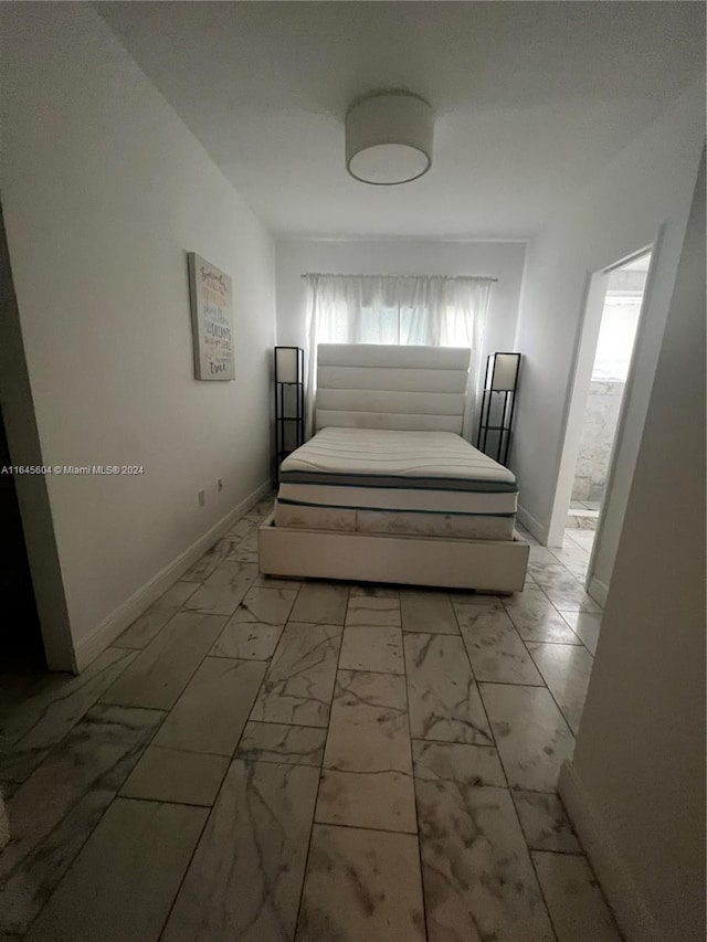 unfurnished bedroom featuring multiple windows and light tile patterned floors