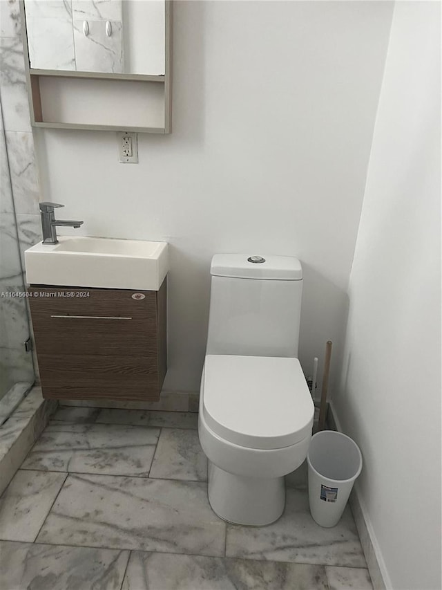 bathroom with tile patterned flooring, vanity, and toilet