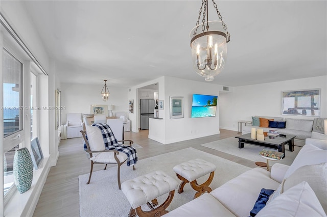 living room featuring light hardwood / wood-style flooring and a chandelier