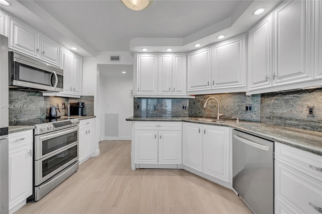 kitchen with stone counters, tasteful backsplash, and stainless steel appliances